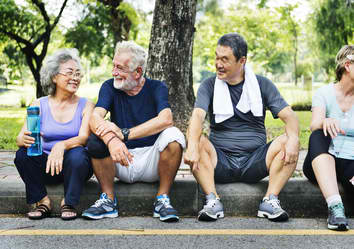 people-of-all-ages-after-exercise-sitting-on-street-curb